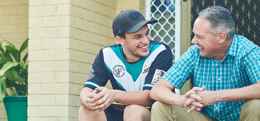 Customer and Support Worker sitting outside talking